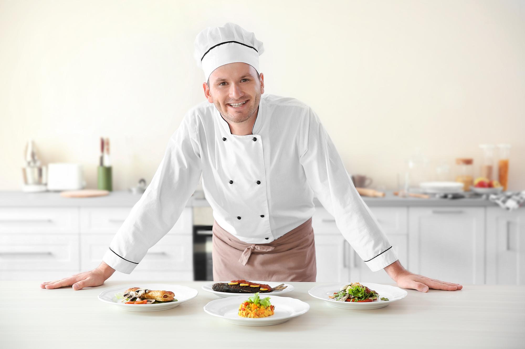 Founder arranging plated meals on a stainless counter